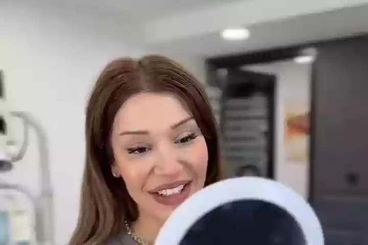 Aftercare – patient checking her new smile in the mirror